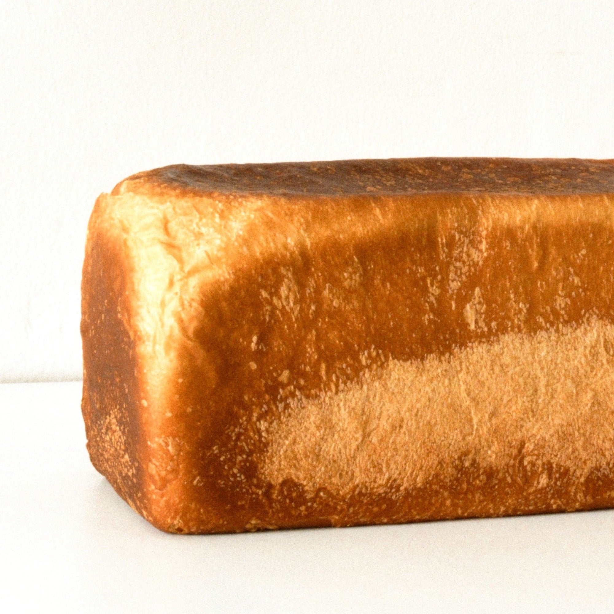 close up image of a golden brown white loaf