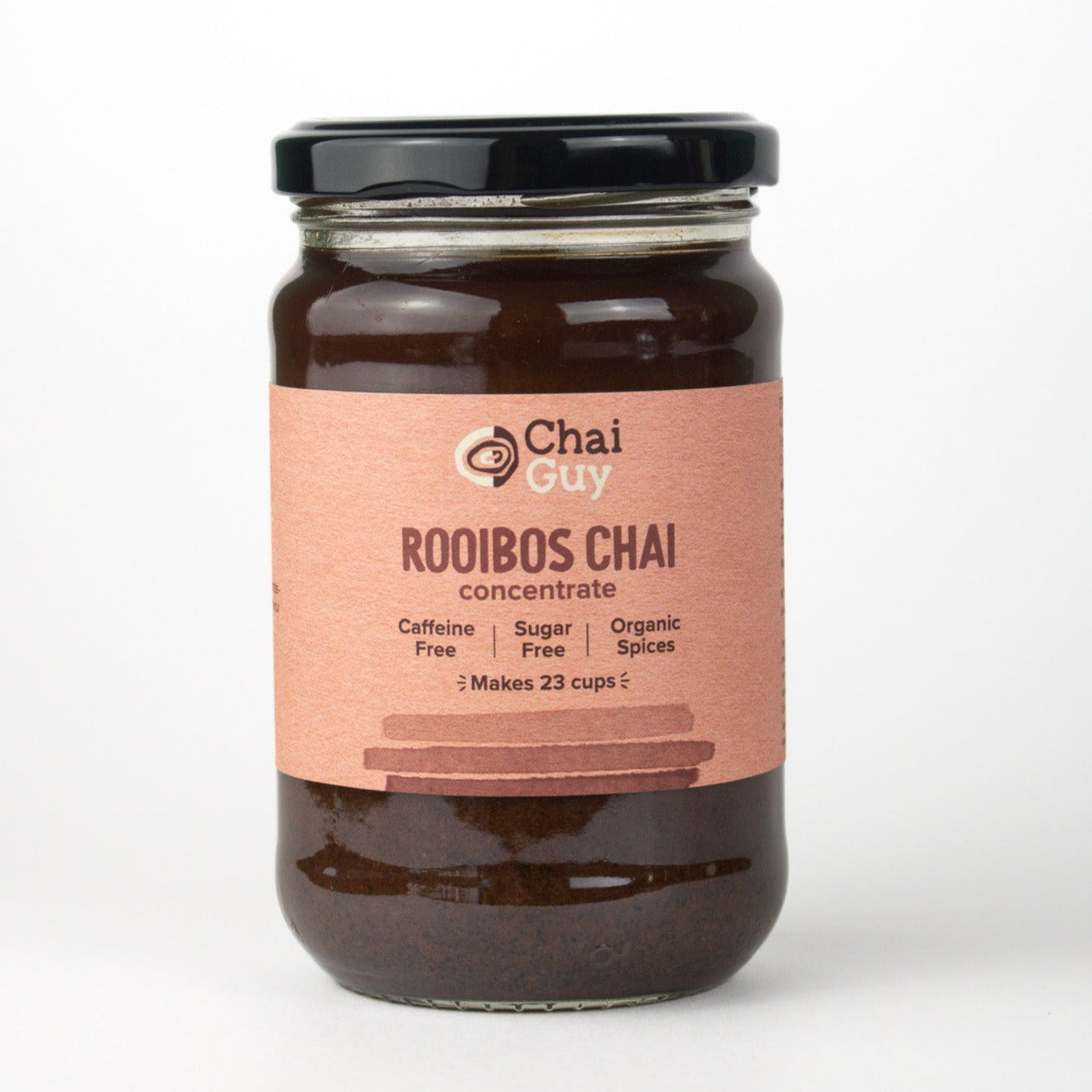 Jar of chai that has an orange label with brown writing. the lid is black. the content of the jar is a brown liquid
