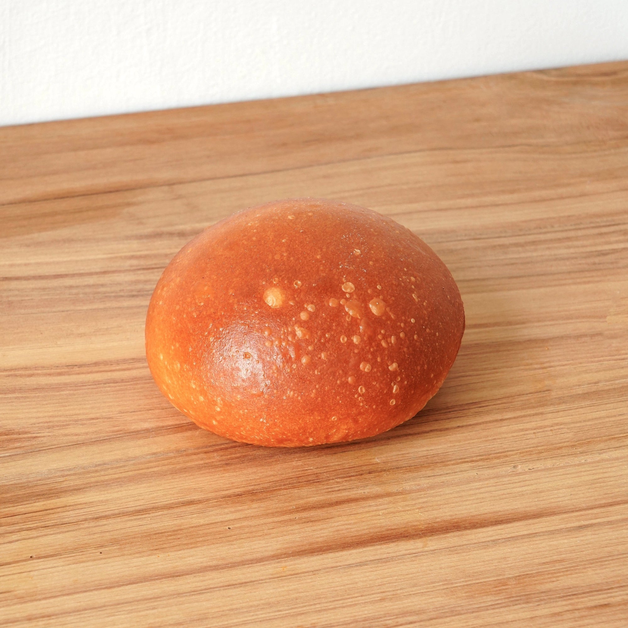 image of the whole burger bun. it is golden brown