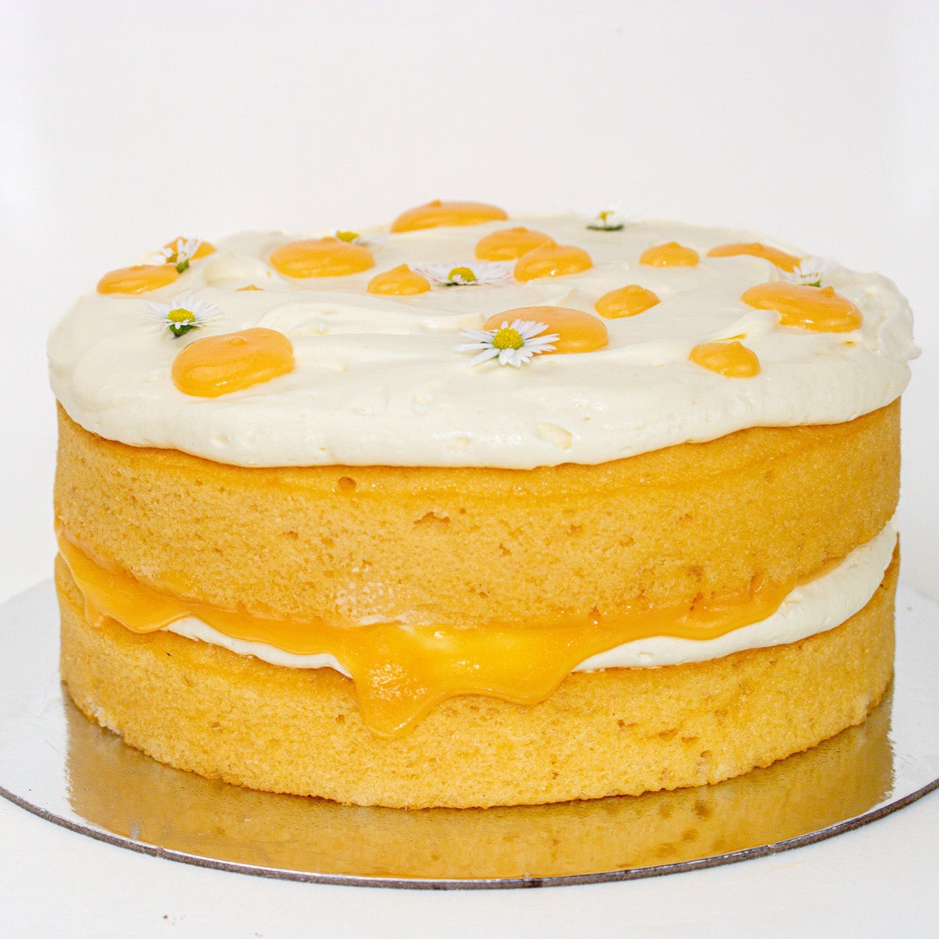 image of a two tiered lemon cake with white mascarpone icing and yellow lemon curd