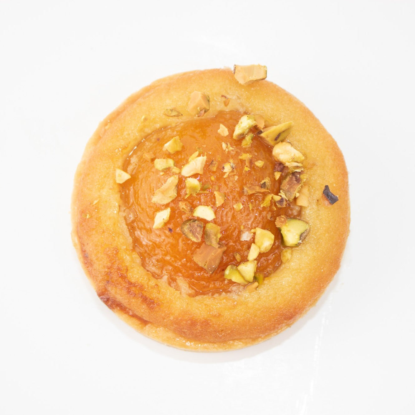 Image of top of the apricot tart with pistachios sprinkled on it