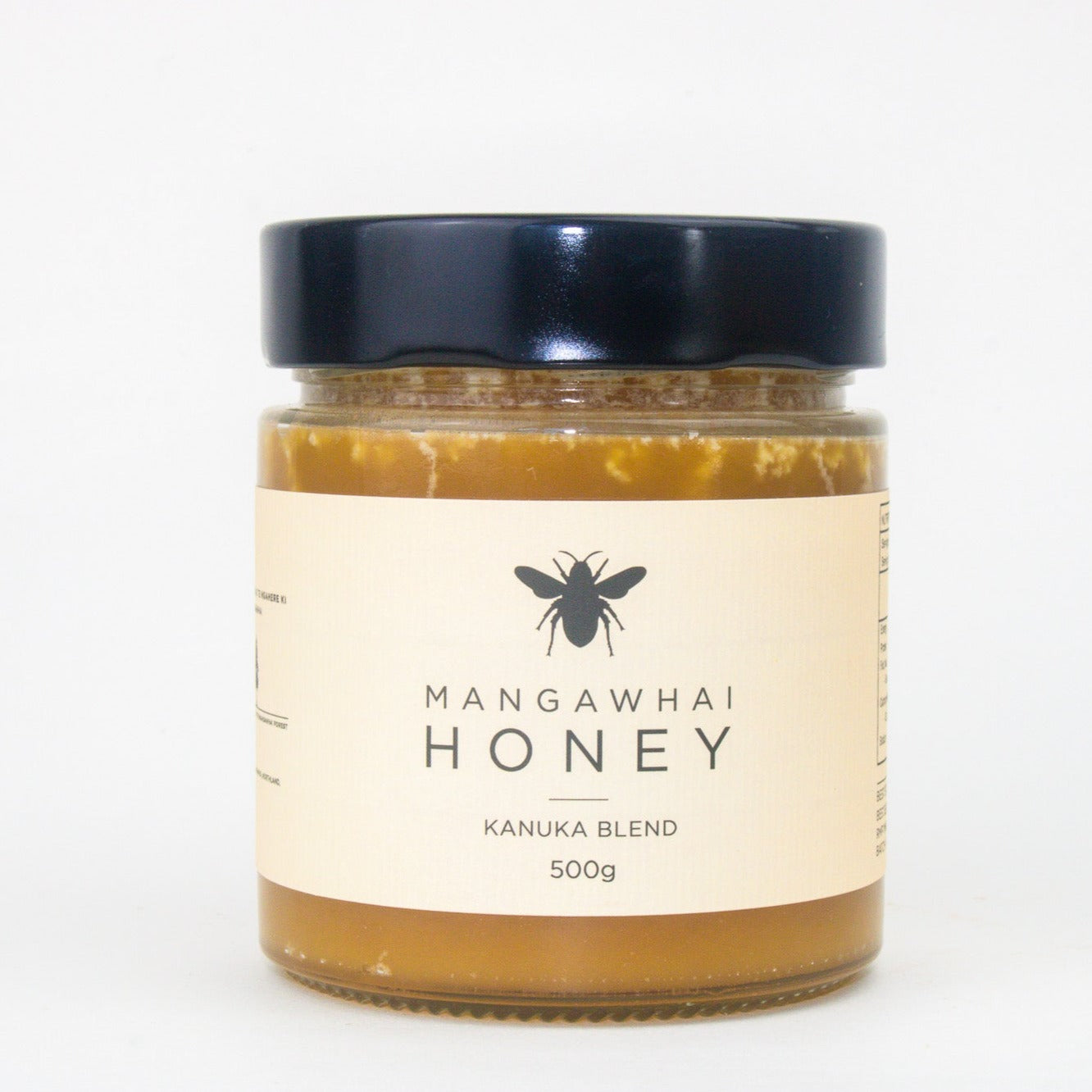 image of a jar of honey with a cream label and black lid