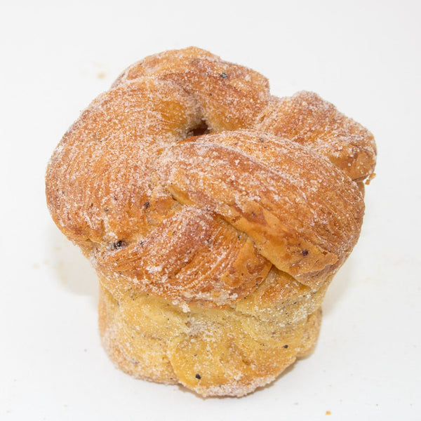 One whole cardamom bun. knotted and covered in sugar