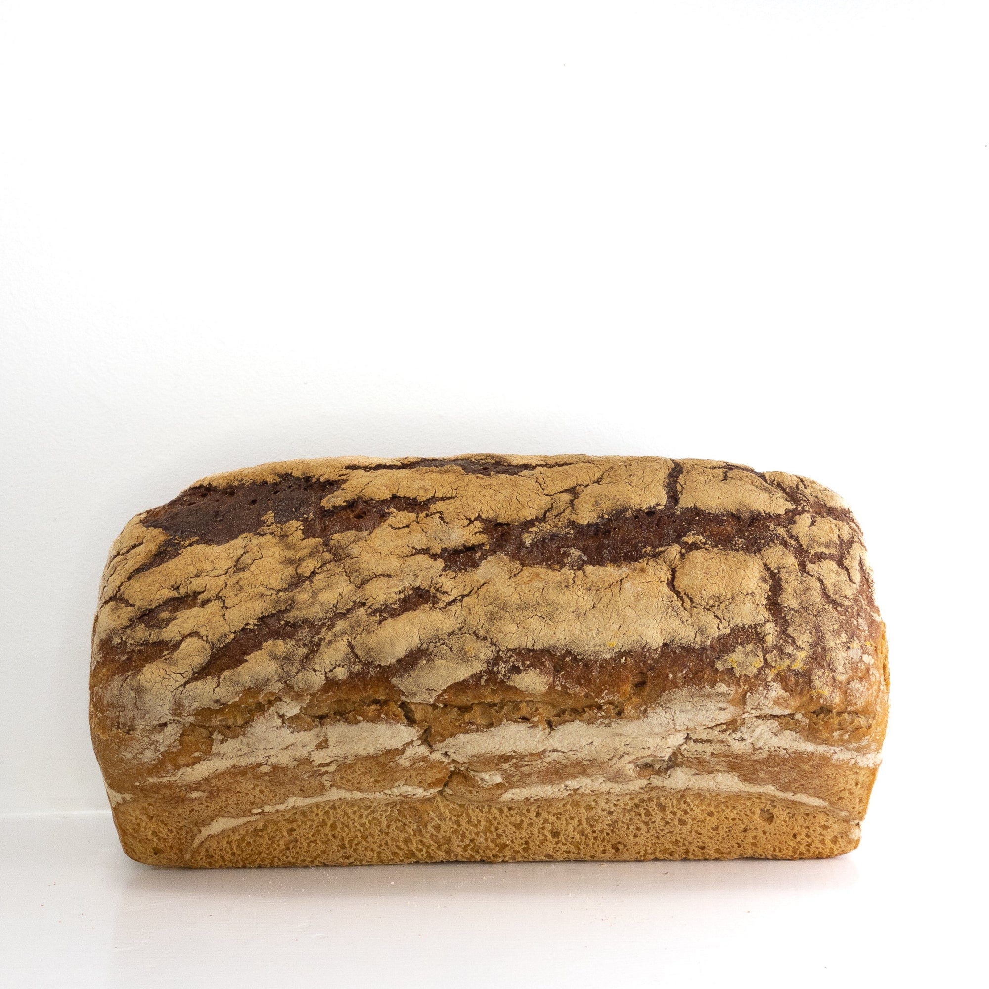 Image of a full rye loaf with differing brown details. 