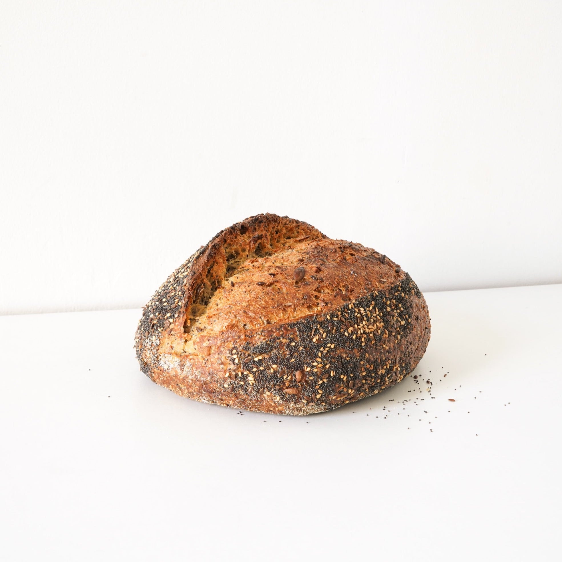 Full image of the seeded loaf. it has whole sunflower, caraway, sesame, pumpkin and poppy seeds.