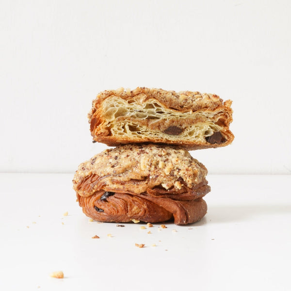 image showing both a whole hazelnut and chocolate pastry, and one that has been cut in half sitting on top