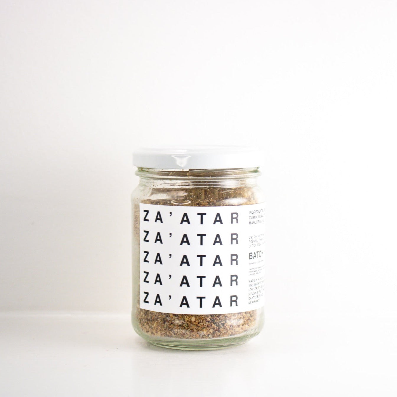 image of a clear jar with a white label and white lid. the label has 'Za'atar' written on it n black five times