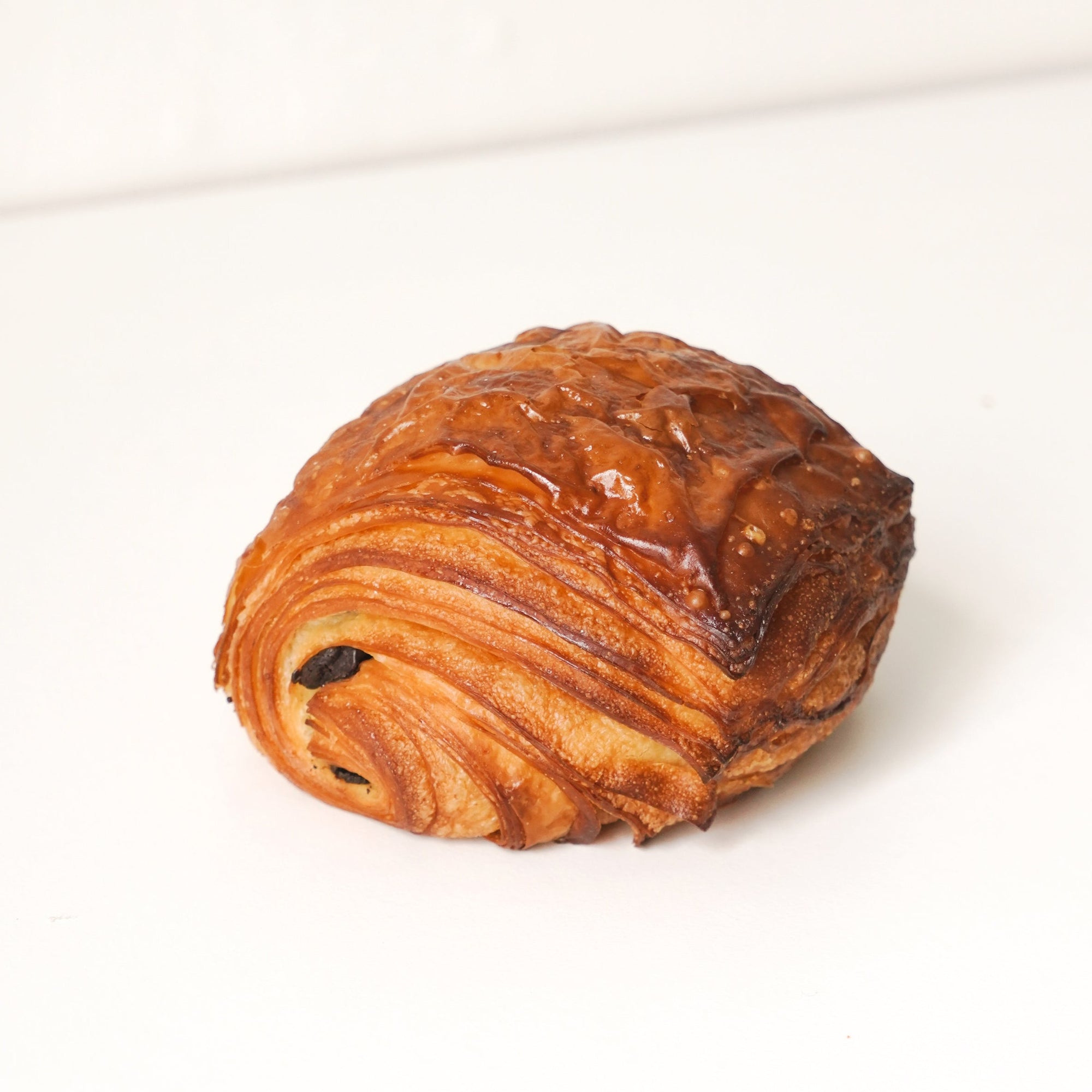 image of a layered pastry. the pastry is golden brown and has a layer of chocolate through the middle